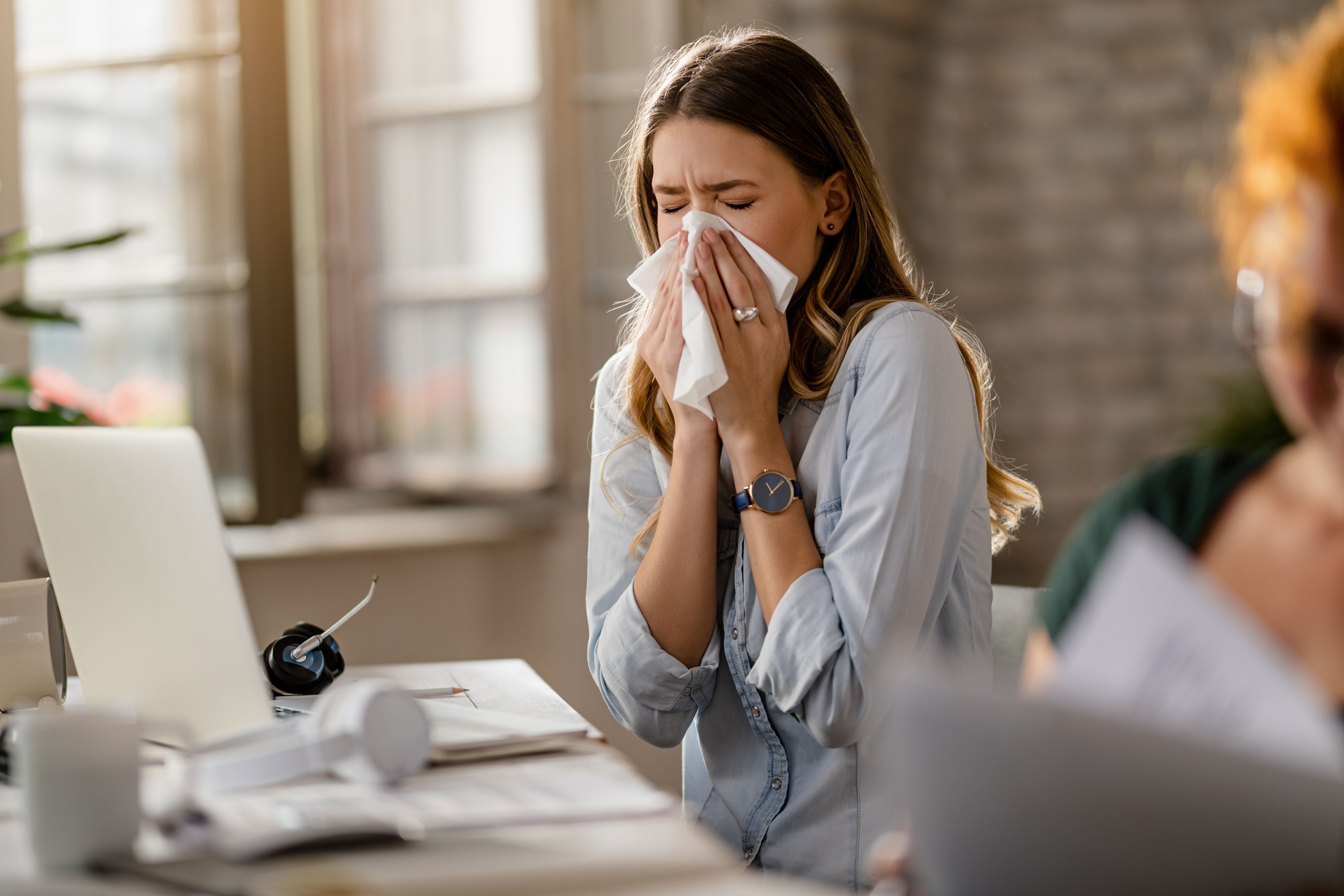 Young Sick Business Woman Sneezing Tissue While Working Office